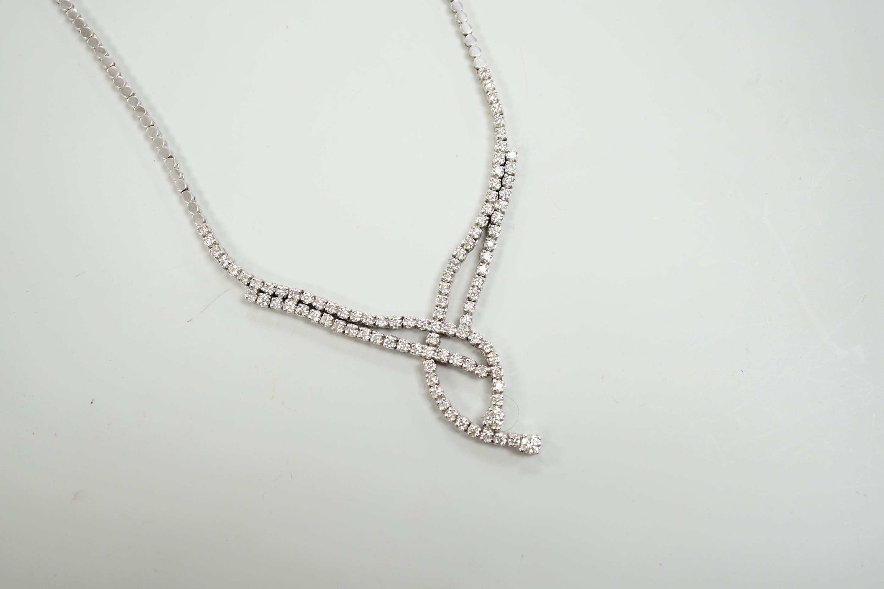A modern 750 white metal and diamond set interwoven necklace, approx. 44cm, gross weight 28.1 grams.